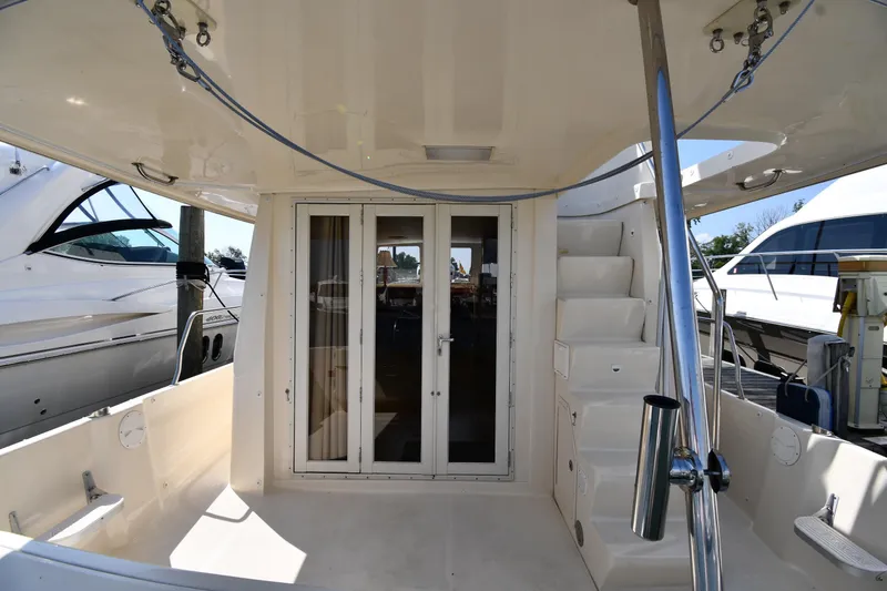 Slide: The Image of 2006 Mainship 40 Trawler aft deck with stairs and glass doors. - 12