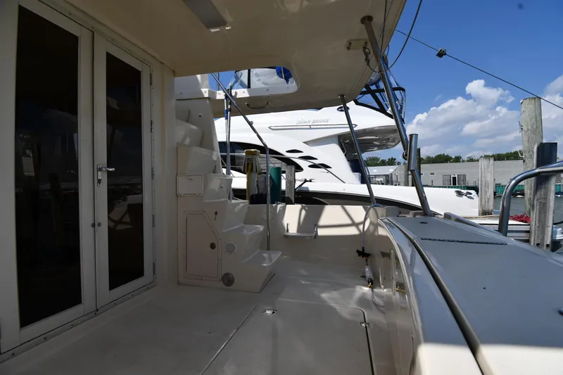 Slide: The Image of 2006 Mainship 40 Trawler docked, featuring spacious deck and modern design. - 13