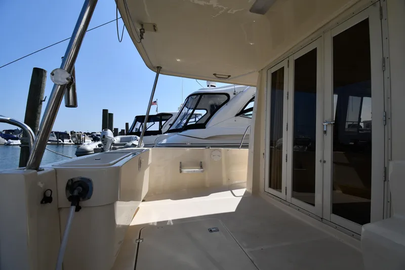 Slide: The Image of 2006 Mainship 40 Trawler deck view with marina background. - 14