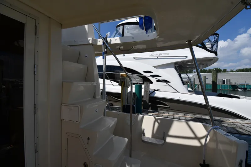 Slide: The Image of 2006 Mainship 40 Trawler interior with stairs, docked near another yacht. - 16