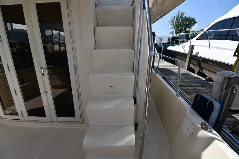 Slide: The Image of Staircase on 2006 Mainship 40 Trawler yacht, leading to upper deck, docked at marina. - 17