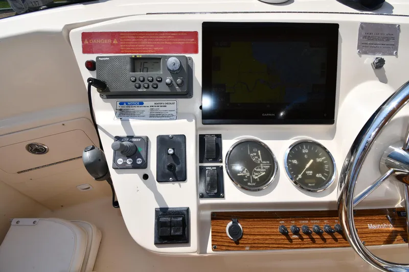 Slide: The Image of 2006 Mainship 40 Trawler helm with navigation instruments and steering wheel. - 23