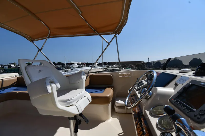 Slide: The Image of 2006 Mainship 40 Trawler helm with captain's chair and navigation equipment under canopy. - 25