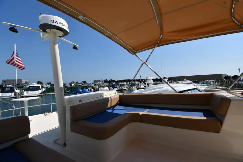 Slide: The Image of 2006 Mainship 40 Trawler with seating, docked at marina under clear blue sky. - 29