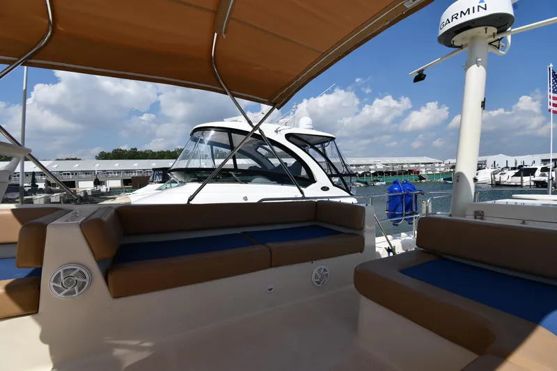 Slide: The Image of 2006 Mainship 40 Trawler with seating area, docked under sunny skies. - 30