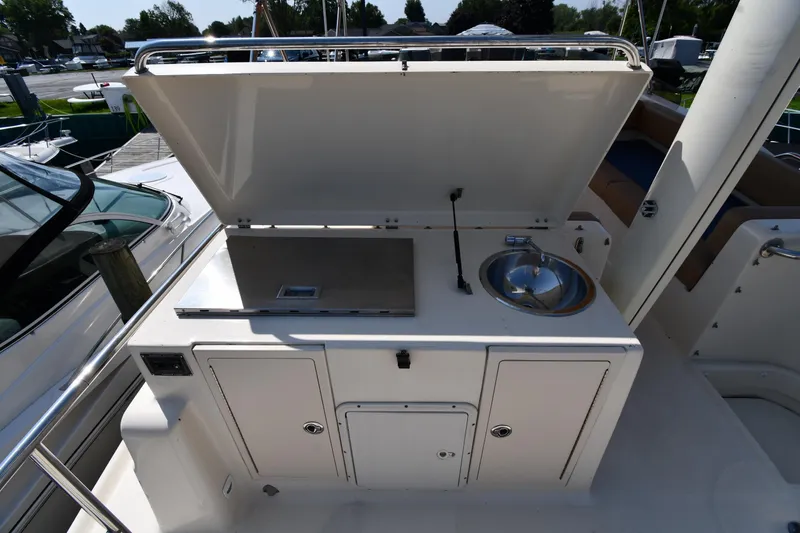 Slide: The Image of 2006 Mainship 40 Trawler outdoor kitchen with sink and grill on deck. - 33