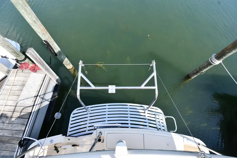 Slide: The Image of 2006 Mainship 40 Trawler docked, viewed from above, with clear water and wooden posts. - 36