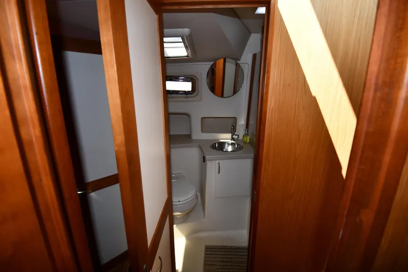 Slide: The Image of Bathroom interior of 2006 Mainship 40 Trawler with wooden accents and modern fixtures. - 46