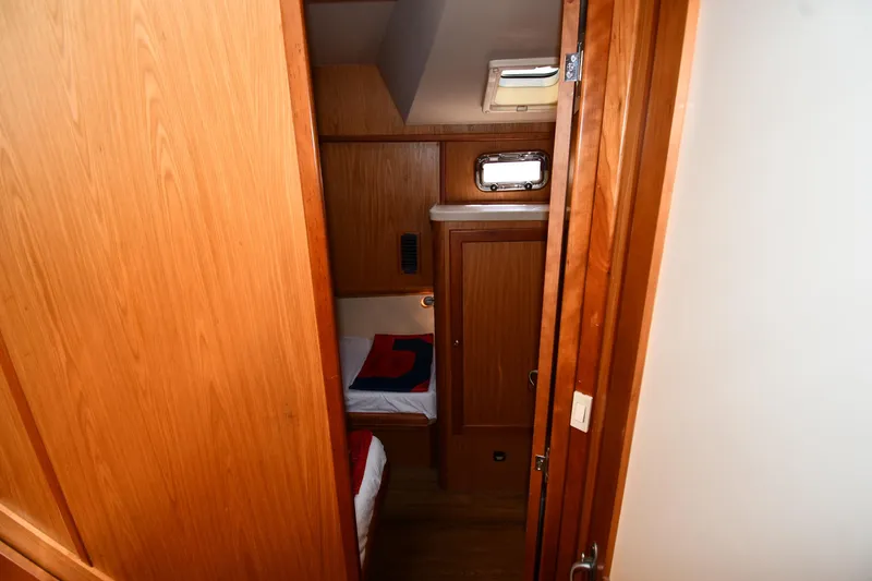Slide: The Image of Cozy cabin interior of 2006 Mainship 40 Trawler with wooden finishes and bedding. - 48