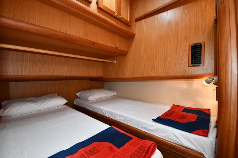 Slide: The Image of Cozy twin cabin in 2006 Mainship 40 Trawler with wooden interior and bedding. - 49