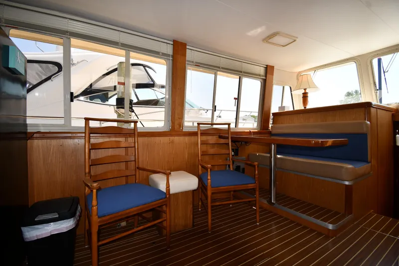 Slide: The Image of Interior of 2006 Mainship 40 Trawler with wooden furniture and blue seating. - 53