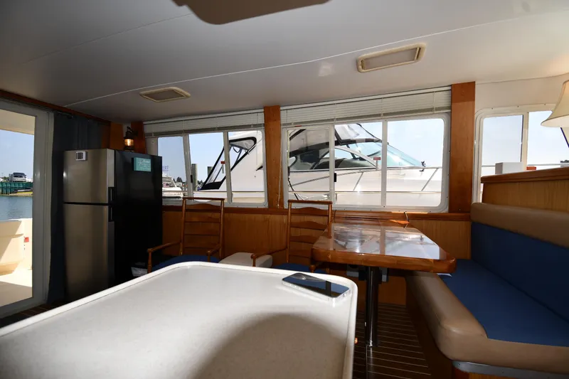 Slide: The Image of Interior of 2006 Mainship 40 Trawler with dining area and large windows. - 54