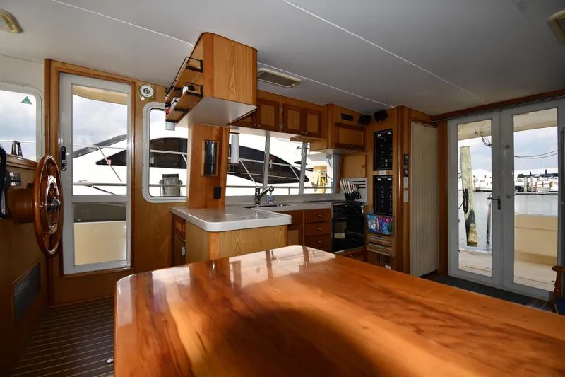 Slide: The Image of Interior of 2006 Mainship 40 Trawler with wooden cabinetry and nautical decor. - 55