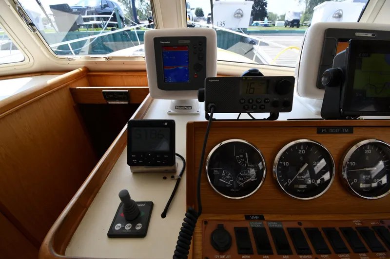 Slide: The Image of Control panel of a 2006 Mainship 40 Trawler with navigation and communication instruments. - 58