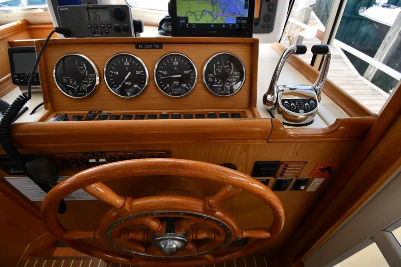 Slide: The Image of 2006 Mainship 40 Trawler helm with wooden wheel, gauges, and navigation equipment. - 60