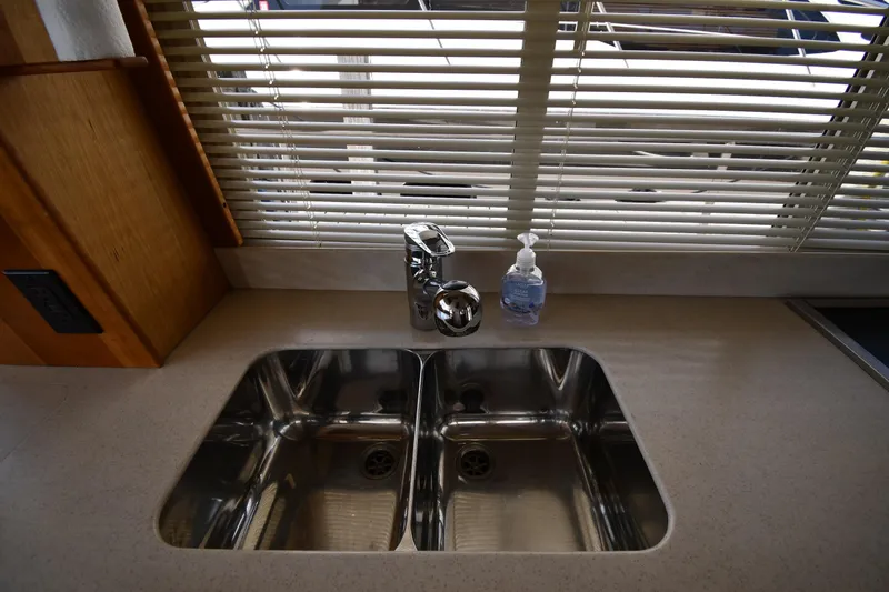 Slide: The Image of Modern kitchen sink in 2006 Mainship 40 Trawler with dual basins and soap dispenser. - 62