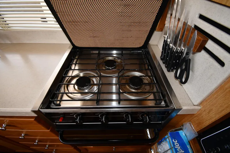 Slide: The Image of Galley kitchen in 2006 Mainship 40 Trawler with stove and knife set. - 64