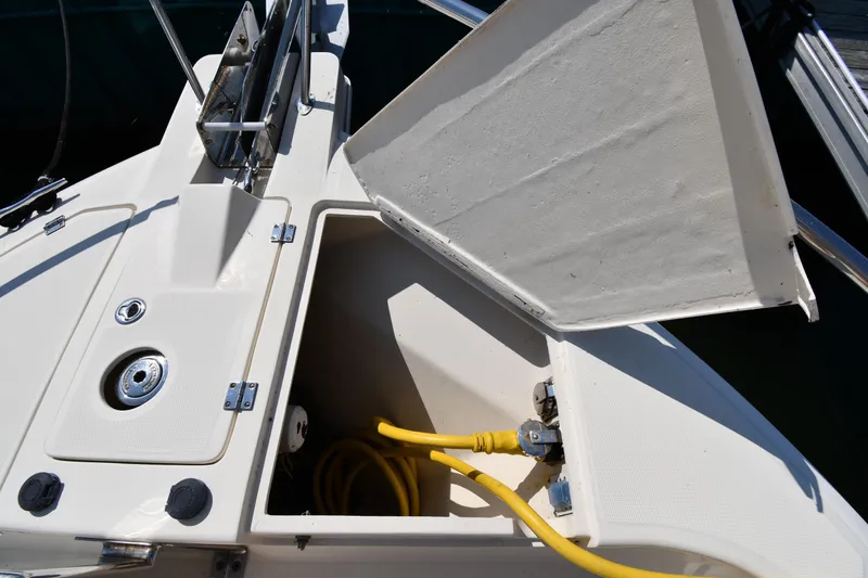 Slide: The Image of Open storage compartment on 2006 Mainship 40 Trawler with yellow hose inside. - 7
