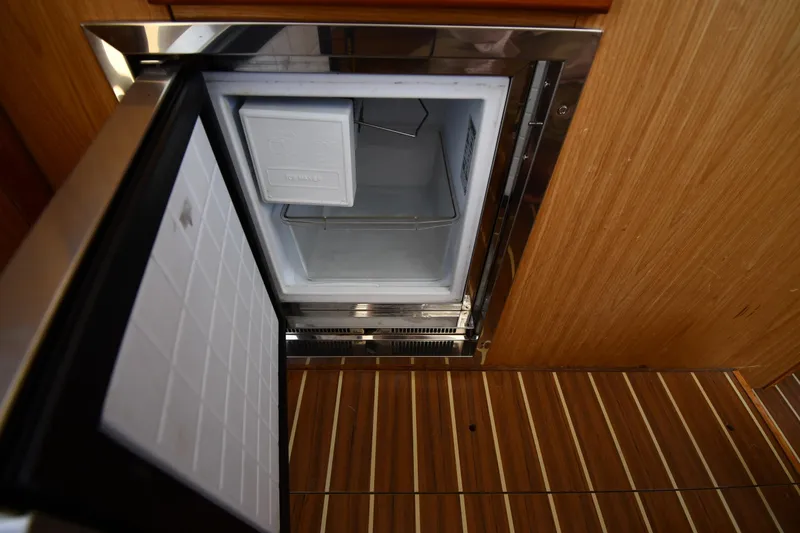 Slide: The Image of Open freezer on 2006 Mainship 40 Trawler, showcasing wooden interior and stainless steel finish. - 72