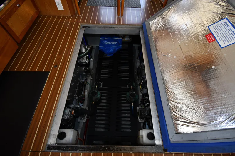 Slide: The Image of Engine compartment of 2006 Mainship 40 Trawler with wooden flooring and insulation. - 73