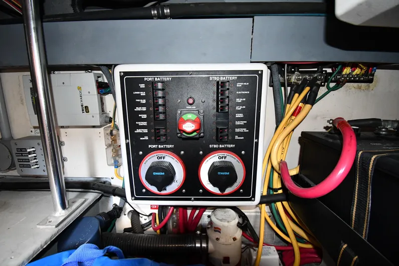 Slide: The Image of Electrical panel of a 2006 Mainship 40 Trawler with battery controls and wiring. - 80