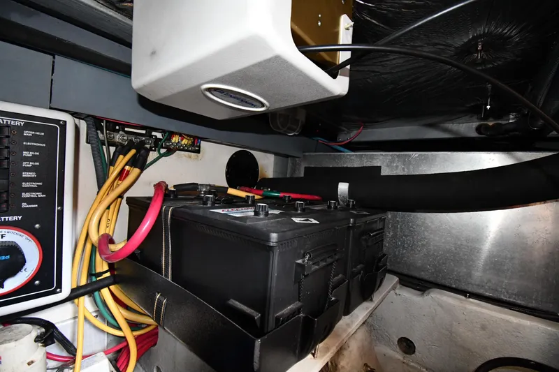 Slide: The Image of Engine room of 2006 Mainship 40 Trawler showing battery and wiring setup. - 82