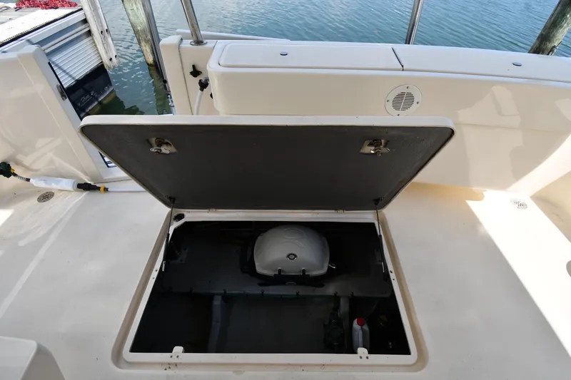 Slide: The Image of Open storage compartment on 2006 Mainship 40 Trawler boat deck by the water. - 87