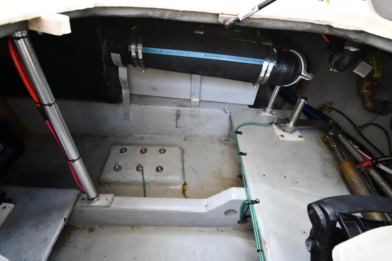 Slide: The Image of Engine compartment of a 2006 Mainship 40 Trawler, showcasing mechanical components and wiring. - 88
