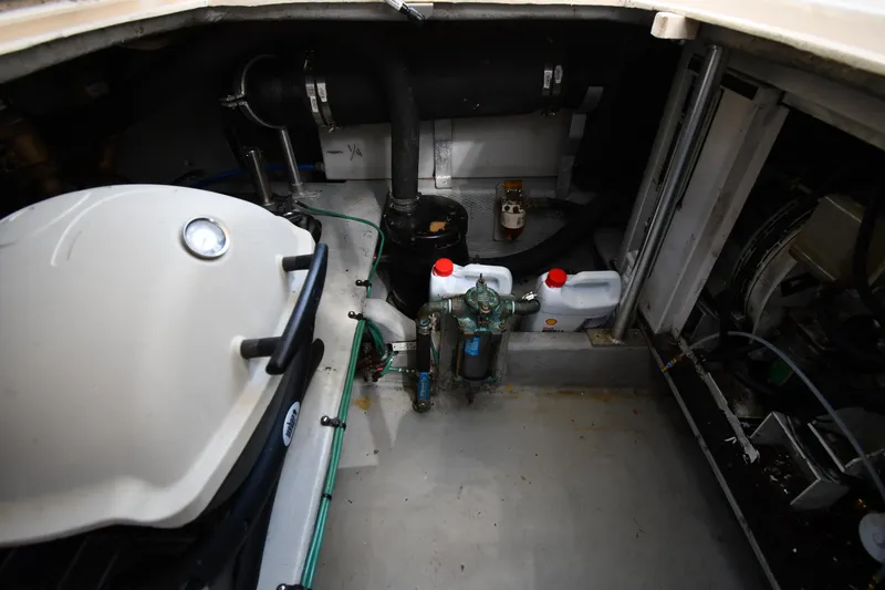 Slide: The Image of Engine room of a 2006 Mainship 40 Trawler with various mechanical components. - 89