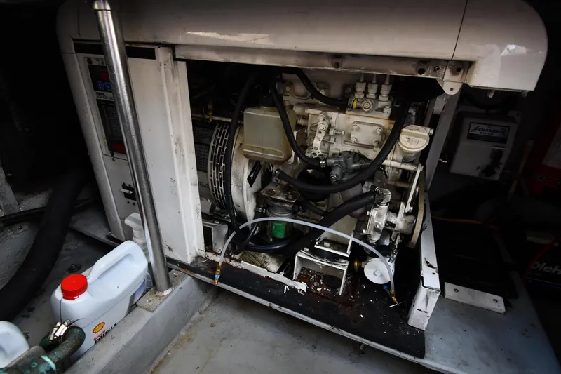 Slide: The Image of Engine compartment of a 2006 Mainship 40 Trawler, showcasing mechanical components. - 90