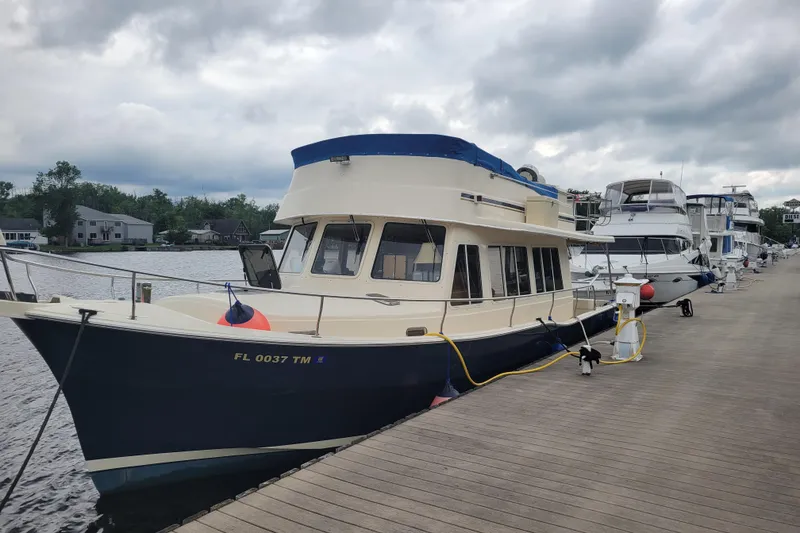 Slide: The Image of 2006 Mainship 40 Trawler docked at marina under cloudy skies. - 95