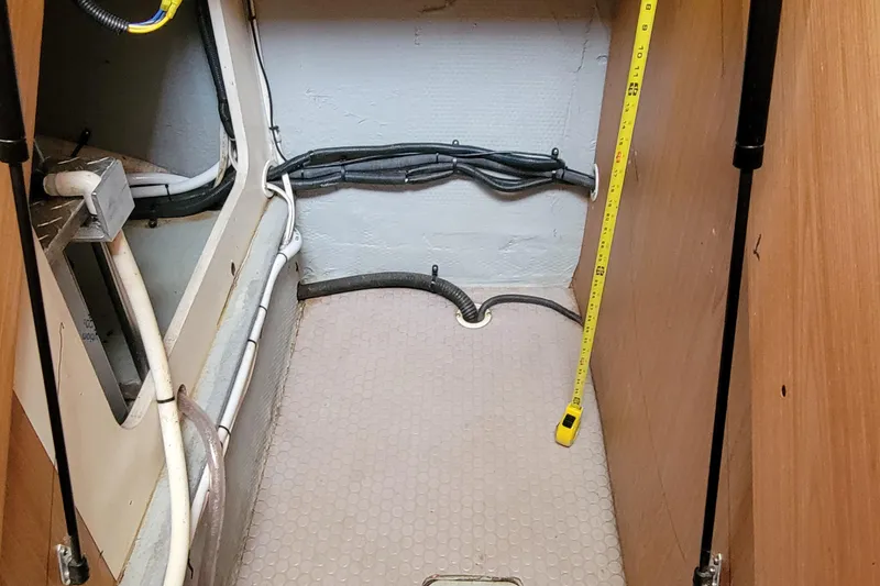 Slide: The Image of 2006 Mainship 40 Trawler interior wiring and plumbing compartment. - 97
