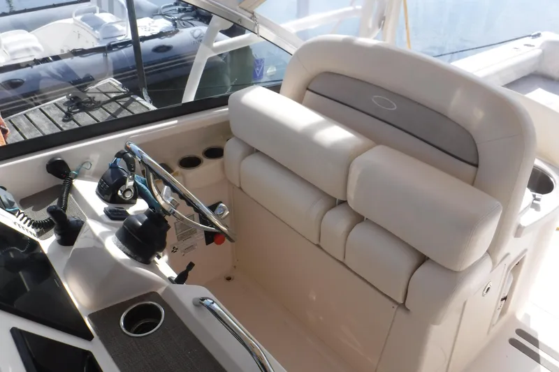 Slide: The Image of 2016 Grady White 355 Freedom boat helm with steering wheel and controls. - 2