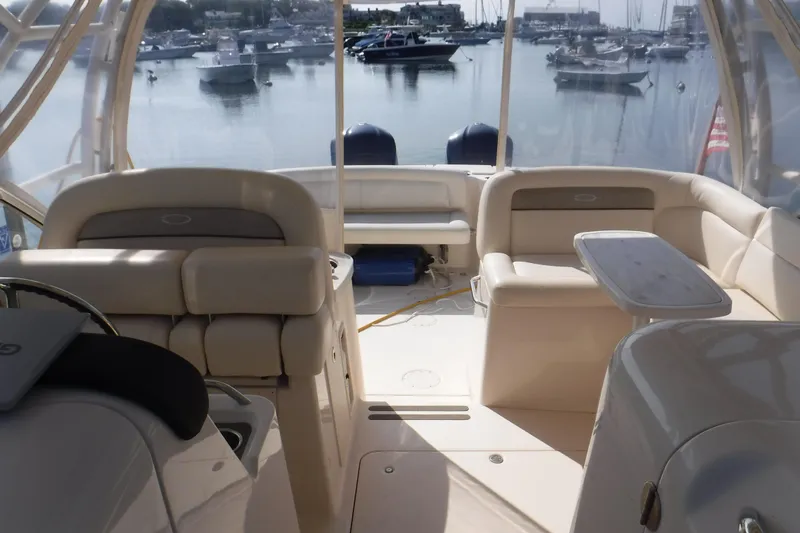 Slide: The Image of 2016 Grady White 355 Freedom boat interior with seating and table, docked in marina. - 5