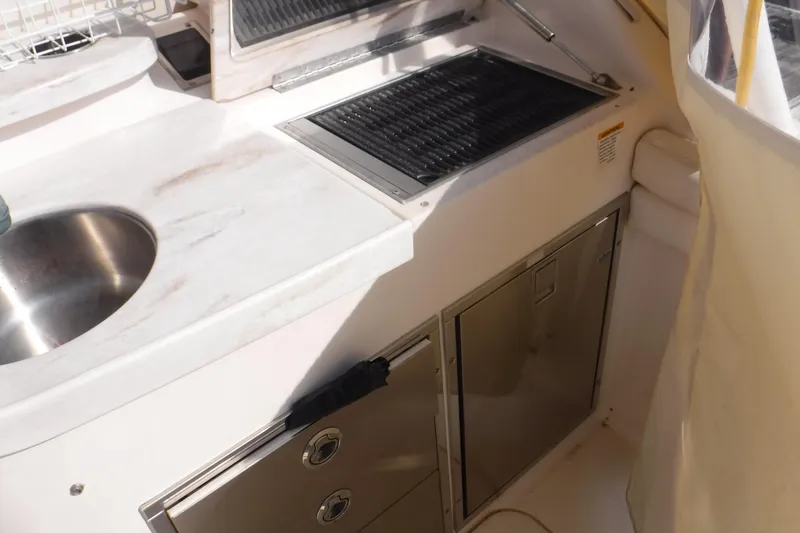 Slide: The Image of 2016 Grady White 355 Freedom boat kitchen area with sink and grill. - 6