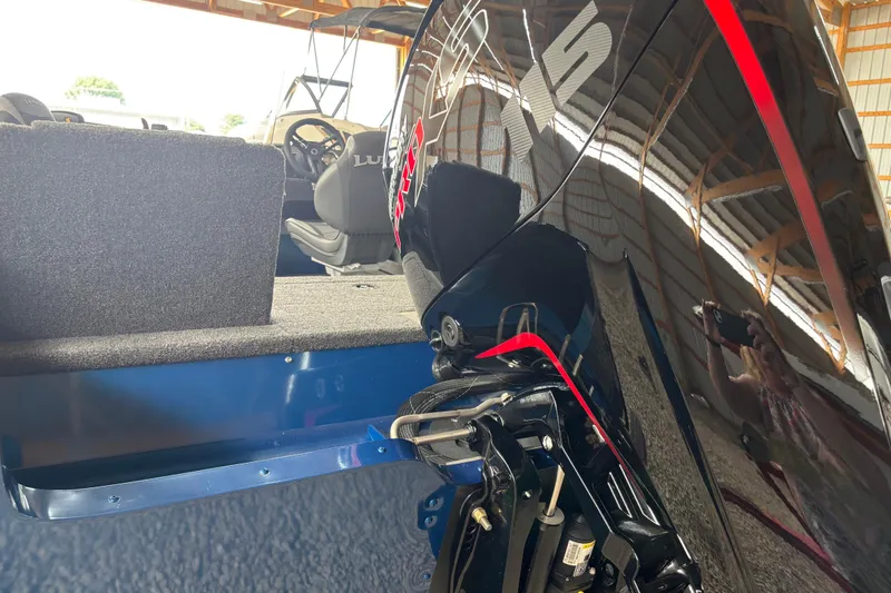 Slide: The Image of 2026 Lund 1775 Adventure SS boat in a storage facility, side view. - 2