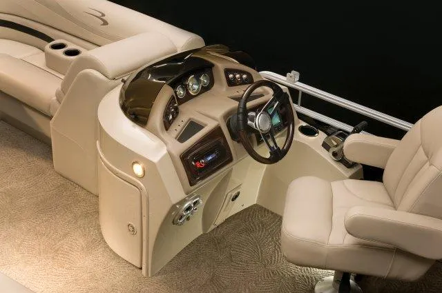 Slide: The Image of Manufacturer Provided Image: 2015 Bennington 2275 GCW boat interior with beige captain's chair and control console. - 11