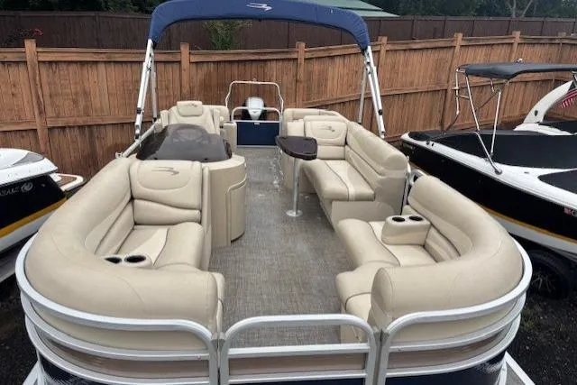 Slide: The Image of 2015 Bennington 2275 GCW pontoon boat with beige seating and blue canopy. - 14
