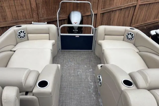 Slide: The Image of 2015 Bennington 2275 GCW pontoon boat interior with beige seating and Yamaha 115 outboard motor. - 15