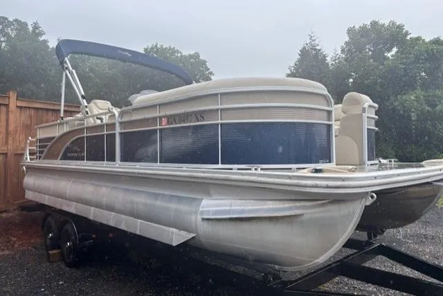 Slide: The Image of 2015 Bennington 2275 GCW pontoon boat on trailer, parked outdoors in rainy weather. - 3