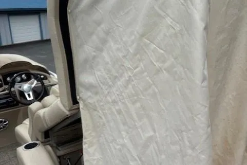 Slide: The Image of 2015 Bennington 2275 GCW boat interior with steering wheel and protective cover. - 8