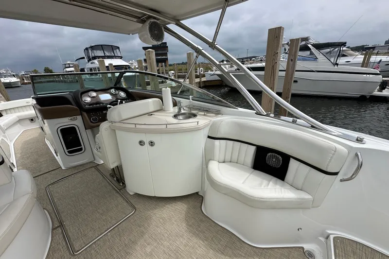 Slide: The Image of Interior of a 2015 Cobalt 336 boat with luxurious seating and control panel. - 10