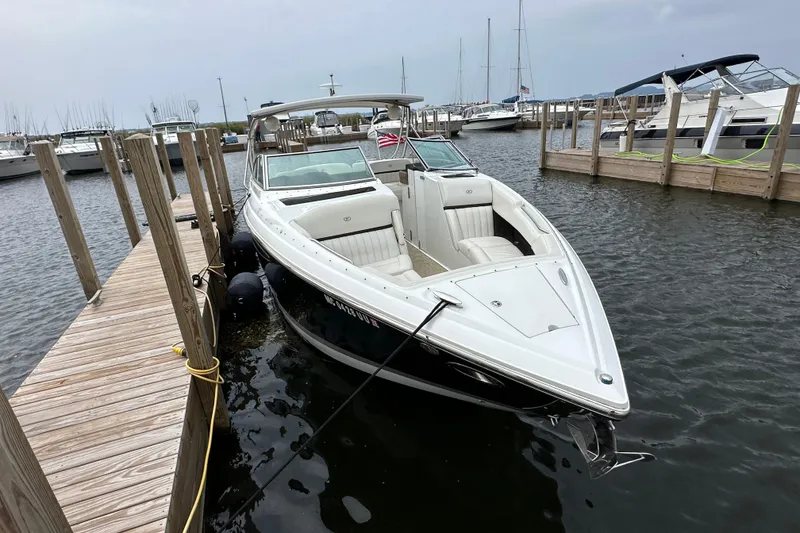 Slide: The Image of 2015 Cobalt 336 boat docked at marina, featuring sleek design and spacious seating. - 2