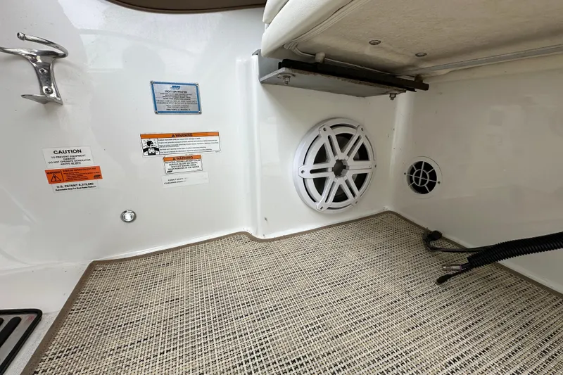 Slide: The Image of Interior of 2015 Cobalt 336 boat showing speakers and safety labels. - 22