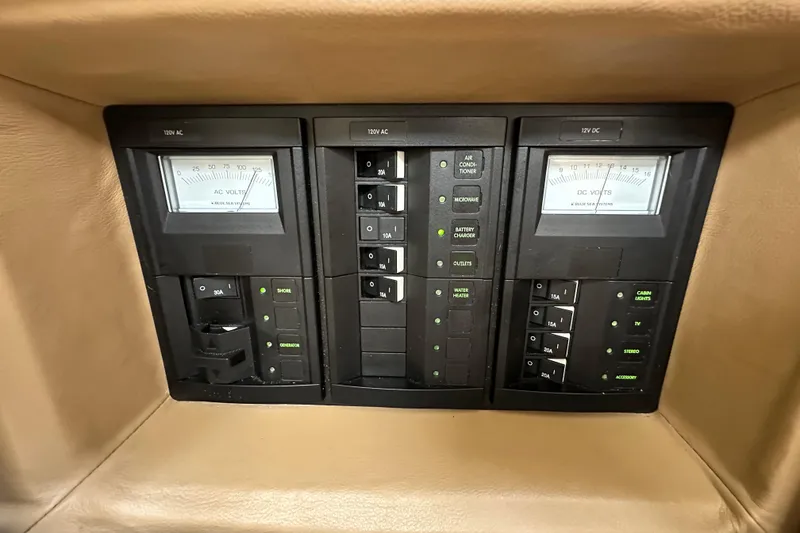 Slide: The Image of Control panel of a 2015 Cobalt 336 boat with AC and DC voltage meters. - 26