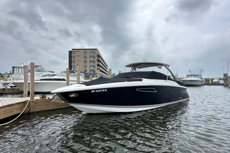Slide: The Image of 2015 Cobalt 336 boat docked at marina under cloudy skies. - 28