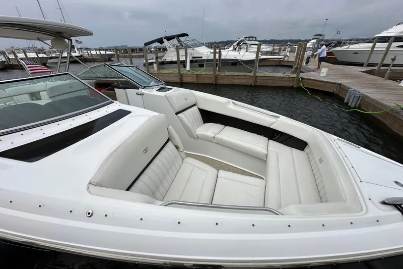Slide: The Image of 2015 Cobalt 336 boat with white seating docked at marina. - 3