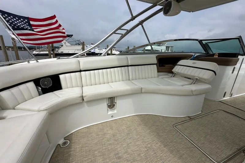 Slide: The Image of Luxurious 2015 Cobalt 336 boat interior with white seating and American flag in background. - 8