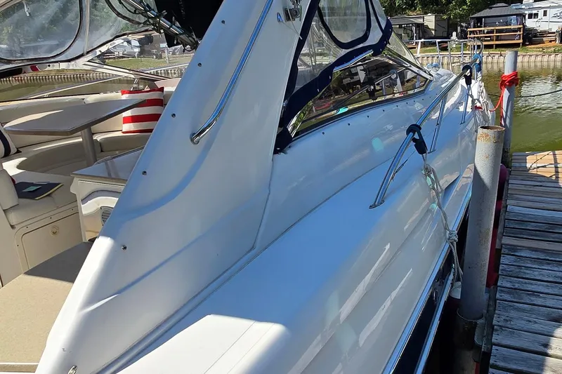 Slide: The Image of 2003 Regal Commodore 4260 yacht docked, showcasing sleek design and spacious interior. - 10