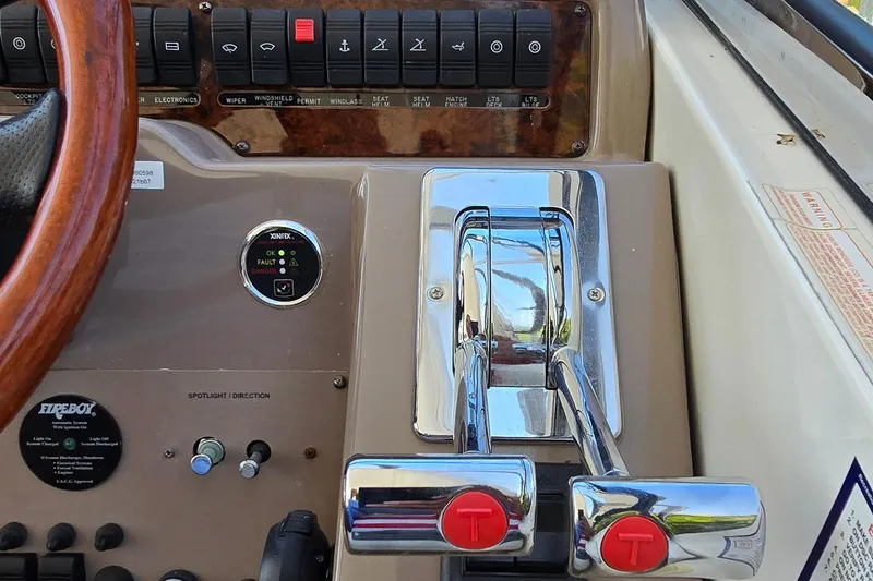 Slide: The Image of Control panel of a 2003 Regal Commodore 4260 boat with chrome throttle levers. - 14